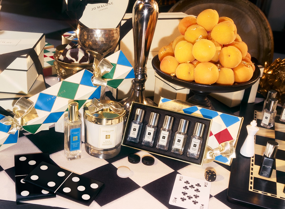 Jo Malone London christmas products candle, cologne collection, cracker on checkered background