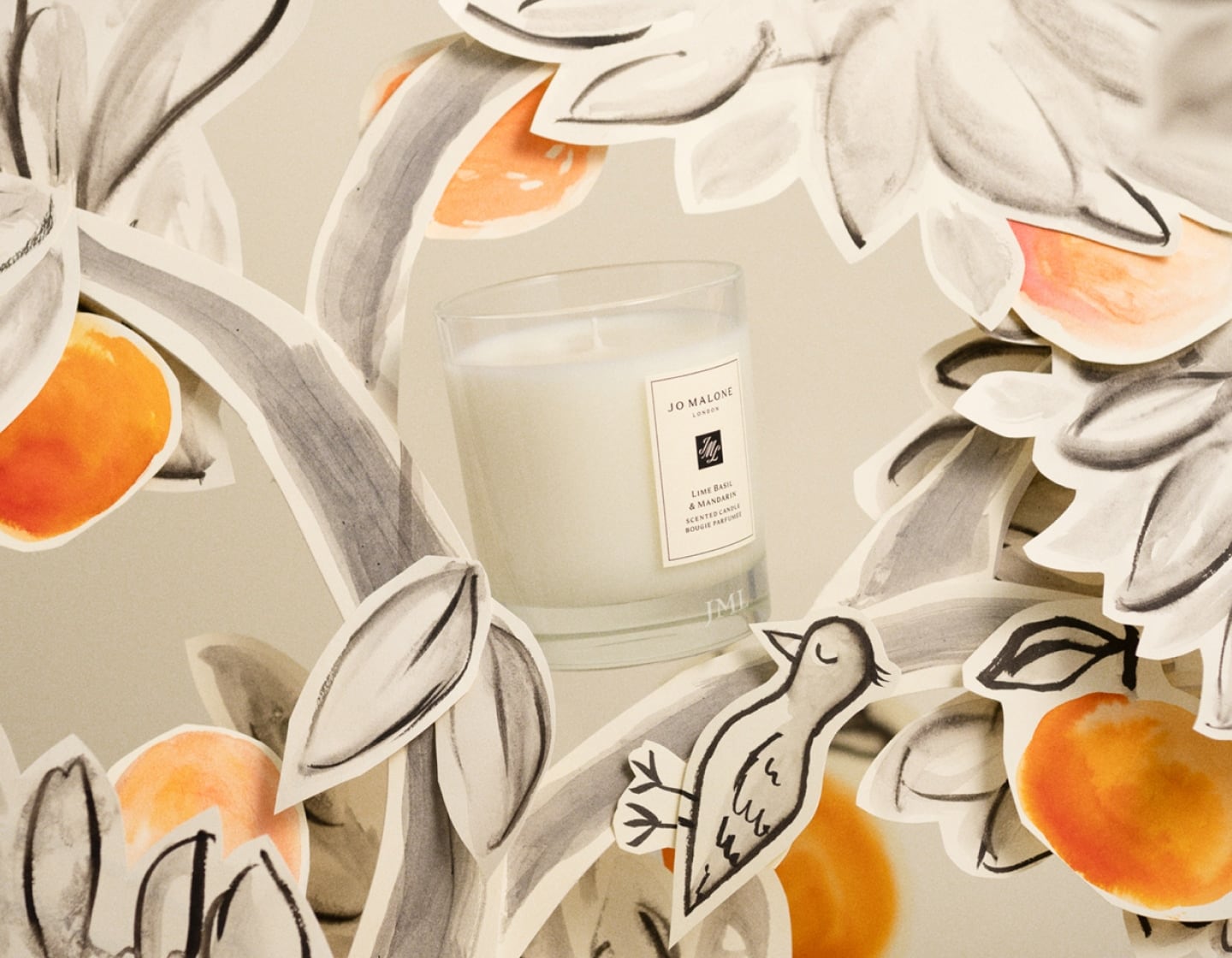 Engraved Lime Basil & Mandarin Candle surrounded by illustrated trees and oranges
