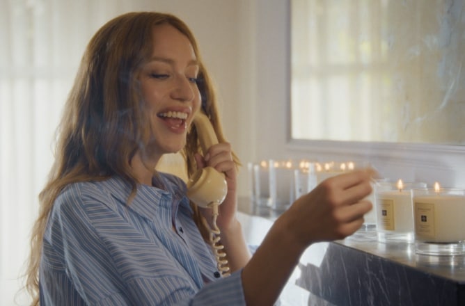 Jagger Sister on phone and lighting candles
