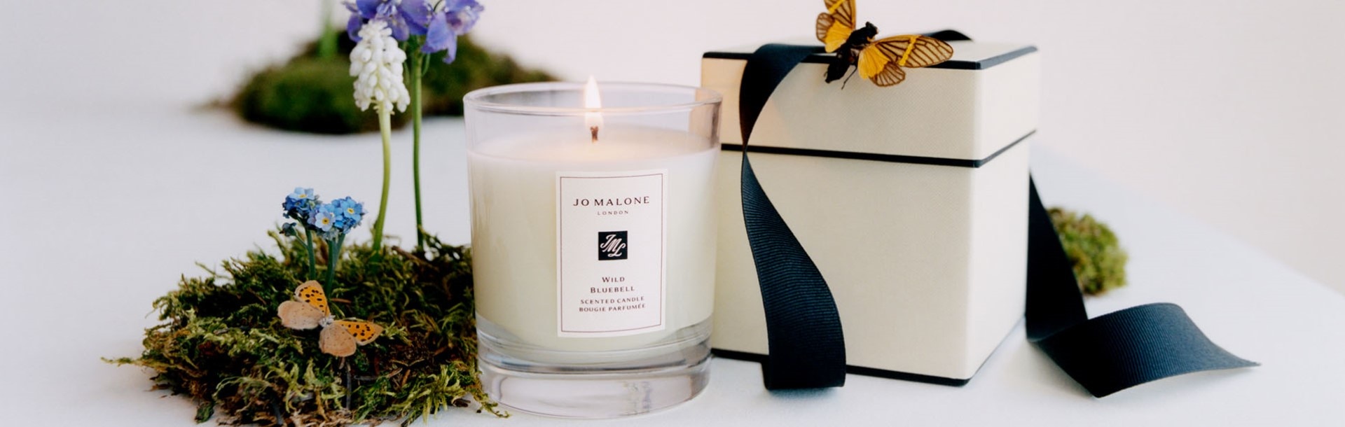 Image of a Jo Malone London Home Candle with butterflies and miniature plants